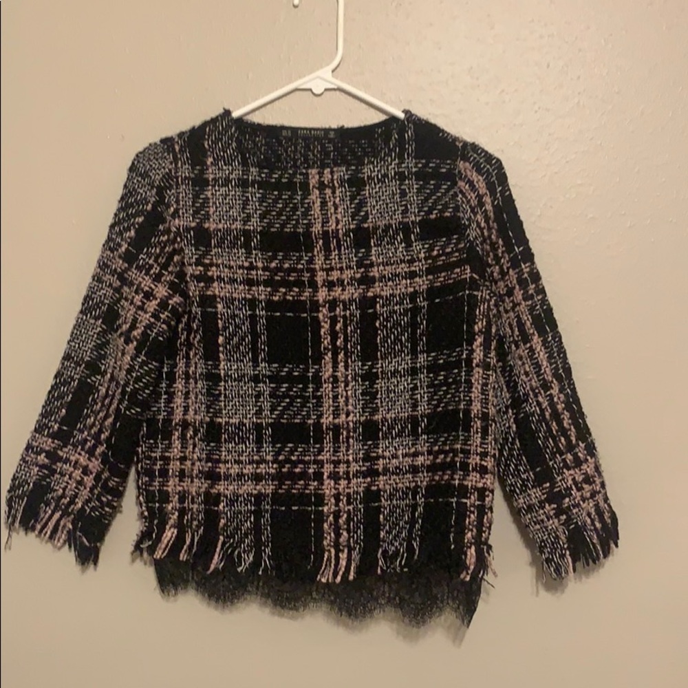 a squared pink and white and black shirt.